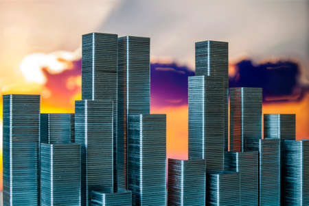Staples arranged to form city skyline on a sunset backgroundの写真素材