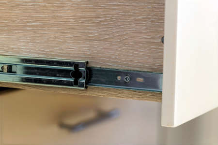 A detail close up shot of a laminate stylish kitchen drawerの写真素材