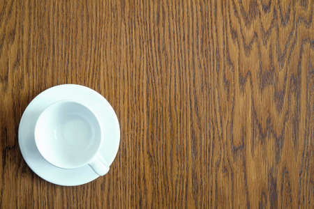 Coffee white cup on wooden table background, top view.の写真素材