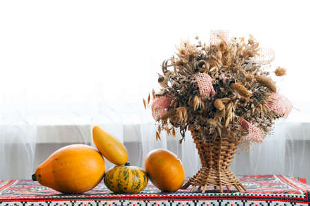 Beautiful autumn composition of Basket with healing herbs dried grass and flowers for use in alternative medicine, spa, herbal cosmetics, herbal medicine, preparing infusions, decoctions, tinctures, powders, ointments, butter, tea, bath. Autumn pumpkins wの写真素材