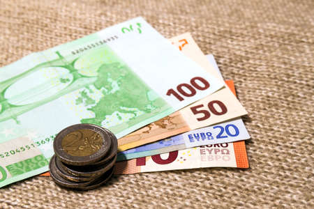 Money euro coins and banknotes stacked on each other in different positions. Money concept. Detail...
