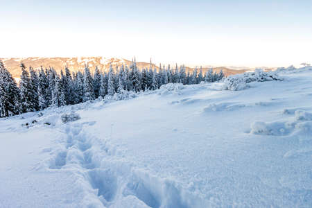 Snow covered hills in mountainsの写真素材
