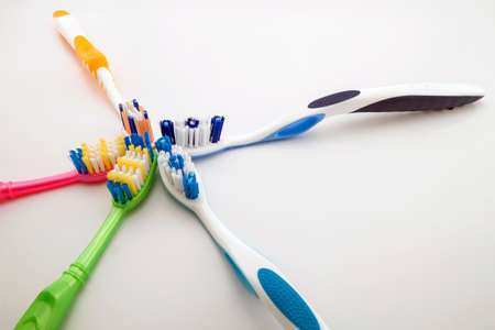 Colorful toothbrushes on white background with copy space. Macro with shallow dof.