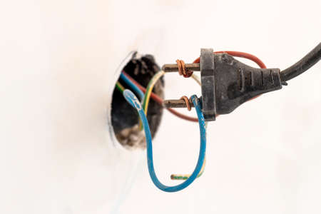 Badly wired plug showing bad and wrong and dangerous connectionの写真素材