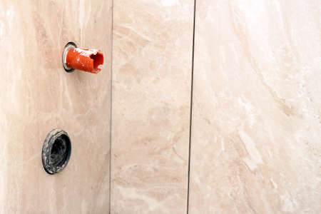 House construction and renovating, pipes and plumbing tools. Bathroom details with installation of pipes. Installing pipes for water supply, heating, sanitation. Workplace plumbing in constructionの写真素材