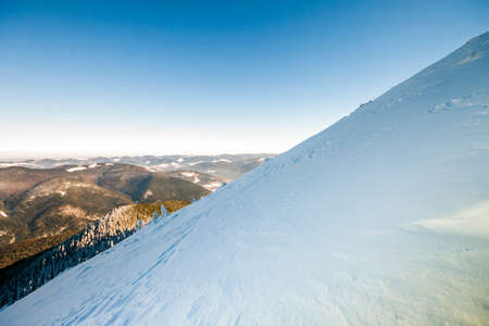 Snow covered hills in mountainsの写真素材