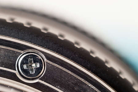 Small metal screw head macro shot wuth blurred background. Shallow depth of field effect.の写真素材