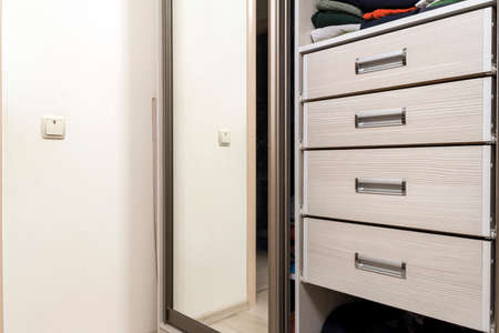 Detail of wooden furniture cabinet chest with drawers front, metal handles, vintage styleの写真素材