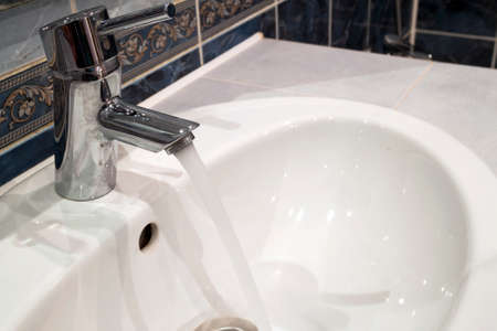 Bathroom interior with sink and faucet valve.の写真素材