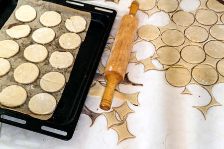 Rolling pin with dough on kitchen table. Preparing dough round tortillas for cookings to be baked.の写真素材