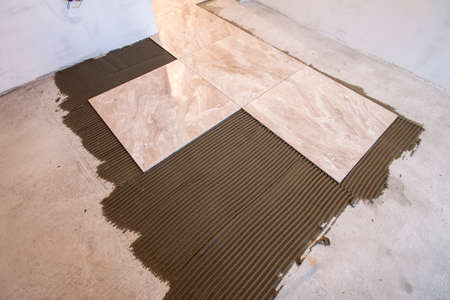 Ceramic tiles and tools for tiler. Floor tiles installation. Home improvement, renovation - ceramic...
