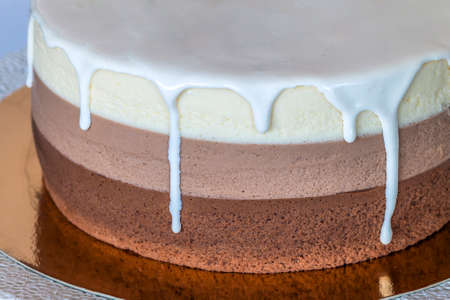 Delicious homemade chocolate marble birthday cake decorated with colorful stripesの写真素材