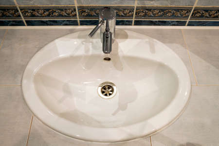 Bathroom interior with sink and faucet valve.の写真素材