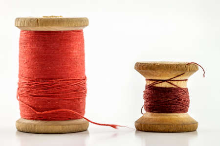 Reels or spools of multicolored sewing threads. Threads of all colors. Shallow depth of field. Close-up macro shot.の写真素材
