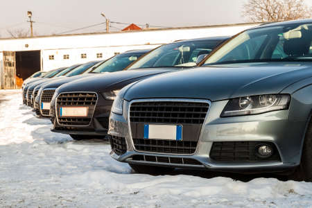 Parked Cars on a Lot. Row of New Cars on the Car Dealer Parking Lot. Cars for Sale Market Theme.
