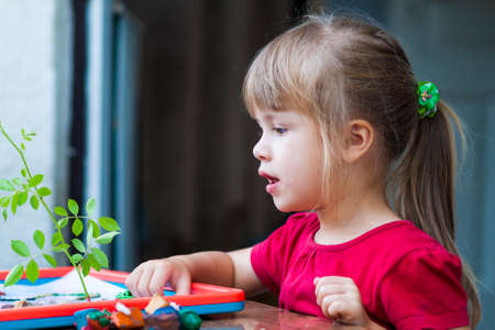 Little cute girl playing table play outsideの写真素材