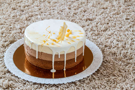 Delicious homemade chocolate marble birthday cake decorated with colorful stripesの写真素材