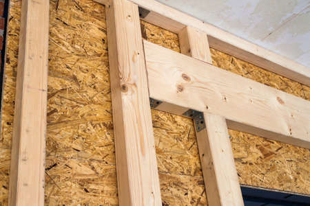 Construction of wood frame walls of a new country house site. Unfinished construction work inside.の写真素材