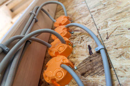 New electrical installation, socket plastic boxes and electrical cables on the wall, renovation concept. Electrical wiring installation.の写真素材