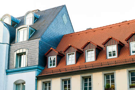 Roofs of old houses with roof windows and orange roof tiles in German city