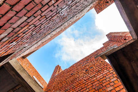 Interior of an old building under construction. Orange brick walls in a new house.の写真素材