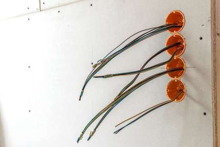 New electrical installation, socket plastic boxes and electrical cables on the wall, renovation concept. Electrical wiring installation.の写真素材