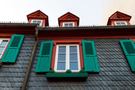 European windows with green wooden shutters in old house. Outdoors exteriorの写真素材