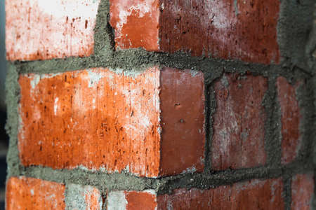 Close up of bricklaying industrial installing bricks on construction site wallの写真素材