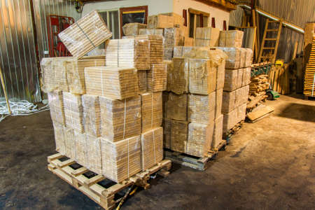 Warehouse packed with variety of timber for construction and repair. Wood timber construction materialの写真素材