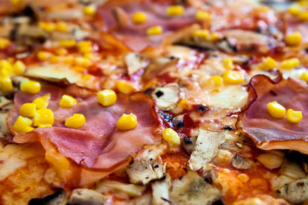 Close up of pizza with meat and corn. Food background.の写真素材