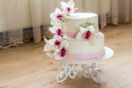 Beautiful wedding cake with flowers, close up of cake with blurred background, selective focus.の写真素材