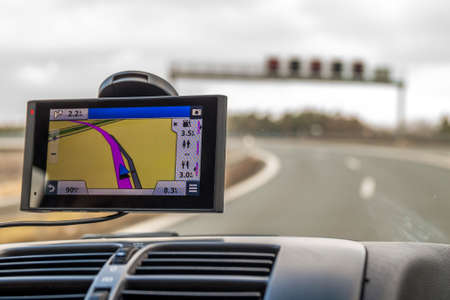 Close-up of gps navigation system device in travelling carの写真素材