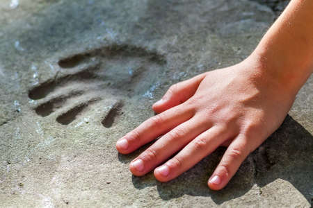 Childs hand and memorable handprint in concreteのeditorial素材