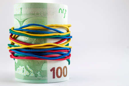 One hundred euro bills money with colourful rubber strings aroundの写真素材
