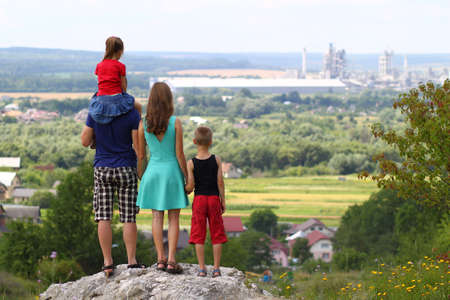 Happy family standing standing on a rock in mountains. Concept of friendly family.の写真素材