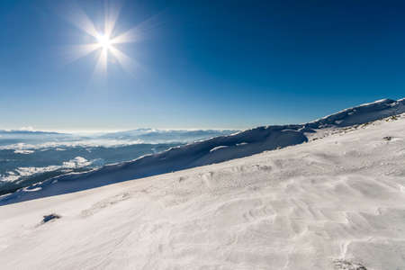 Snow covered hills in winter mountains. Arctic landscape. Colorful outdoor scene, Happy New Year celebration concept.の写真素材