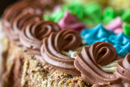 Close-up of sweet colorful cream on top of a cakeの写真素材