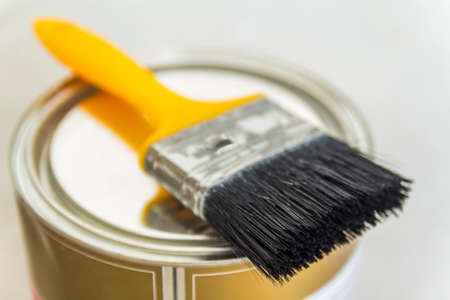 House renovation. Can with paint and a brush tool on concrete backgroundの写真素材