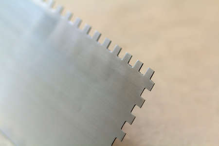 Construction notched trowel is a tool for tiles installation workの写真素材