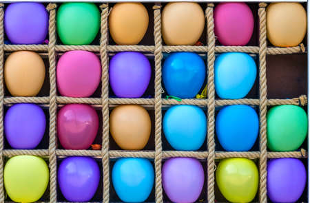 Many colorful air baloons in separate boxesの写真素材