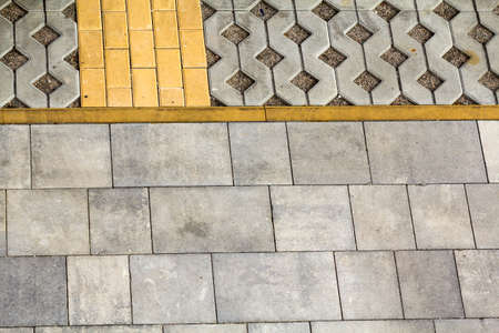Perspective view of gray and yellow brick stones on street and sidewalk