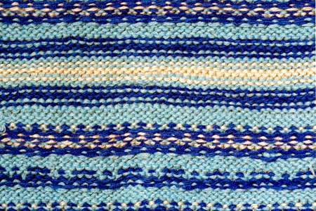 Background texture of blue pattern knitted fabric made of cotton or wool closeup
