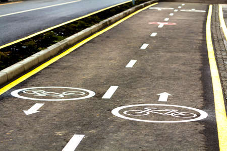 Bicycle lane signs on the asphalt road surfaceの写真素材