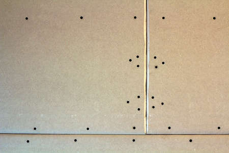 Suspended ceiling from drywall fixed to metal frame with screws.