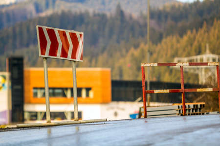 Red road sign to turn right