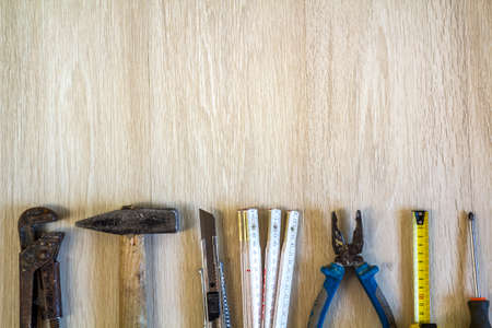 Construction, building and repair tools set for house work on wooden  background. Top view.