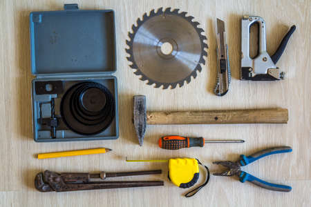 Construction, building and repair tools set for house work on wooden  background. Top view.