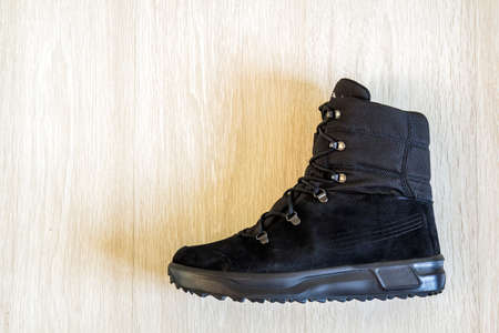 One modern fashionable shoe on wooden  background. Top view.の写真素材