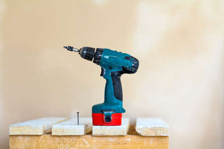 Electric cordless screwdriver and one screw close-upの写真素材