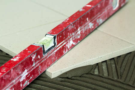Ceramic tiles and tools for tiler. Floor tiles installation. Home improvement, renovation - ceramic...